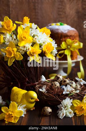 Easter table decoration with fresh daffodils,chick and eggs Stock Photo