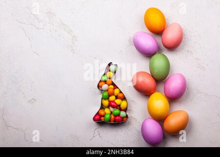 Easter concept with natural dyed easter eggs and candy. Flat lay Stock Photo