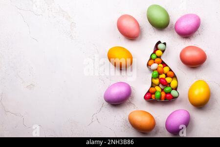 Easter concept with natural dyed easter eggs and candy. Flat lay Stock Photo