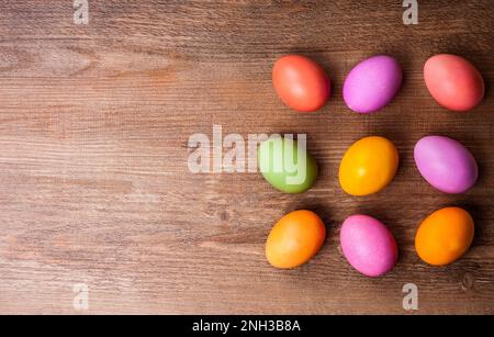 Natural dyed Easter eggs on old wooden background. Easter concept with copy space. Flat lay Stock Photo