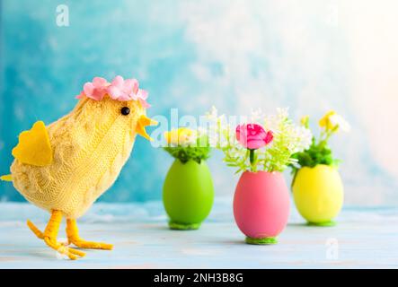 Easter decoration with funny chick and spring flower in colorful dyed eggs Stock Photo
