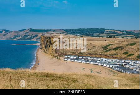 Mobile homes holiday accommodation on beach next to limestone cliffs, Jurassic coast, Burton Freshwater, Dorset, England, UK Stock Photo