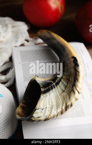 Shofar, kippah and open Torah on table, closeup. Rosh Hashanah celebration Stock Photo