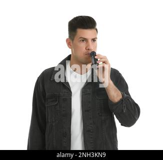 Man blowing into breathalyzer on white background Stock Photo