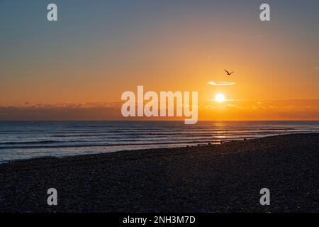 Sun setting over Worthing Beach, West Sussex, UK Stock Photo