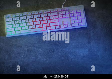 Modern RGB keyboard on grey table, top view. Space for text Stock Photo