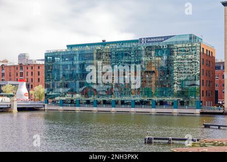 303 Congress Street is a blue-green glass and red brick office building at the water’s edge, on the South Boston side of Fort Point Channel. Stock Photo