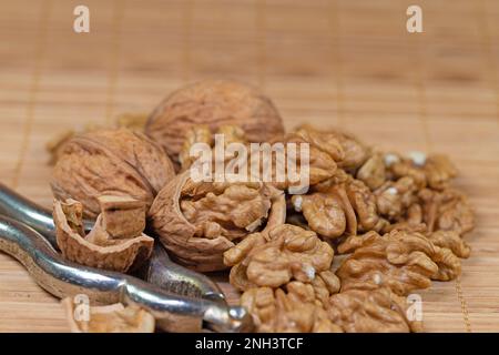 Walnuts and nutcracker in a close-up Stock Photo