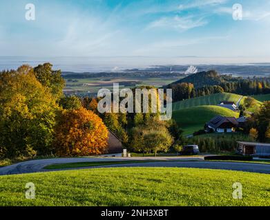 Peaceful autumn sunny morning rural view from Gmundnerberg with misty countryside in far, Altmunster am Traunsee, Upper Austria. Stock Photo