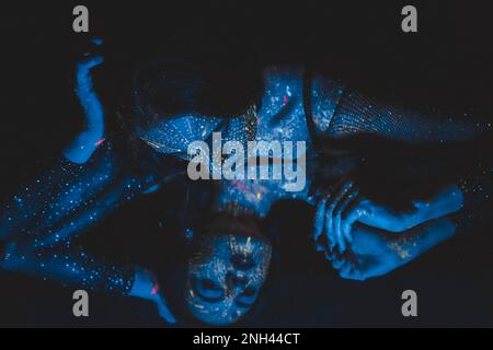 Fashion model woman in neon light, portrait of a beautiful model with fluorescent makeup, artistic design. Cosplay for the movie Avatar. The girl is a Stock Photo