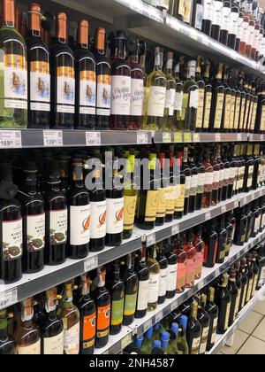 07.02.2023, Ukraine, Kharkiv, a large selection of wines of different varieties on the supermarket shelf Stock Photo