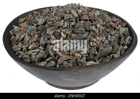 cocoa nibs in a wooden bowl isolated on white background Stock Photo