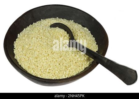 sesame seeds in wooden bowl with spoon isolated on white background Stock Photo