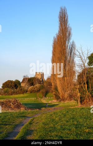 Church in the English countryside with field and trees. Late afternoon just before sunset. St John's Church, West Wickham, Kent, UK. Stock Photo