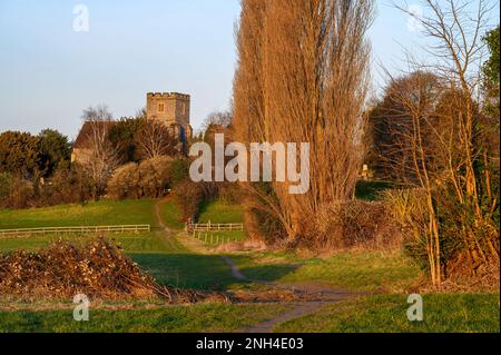 Church in the English countryside with field and trees. Late afternoon just before sunset. St John's Church, West Wickham, Kent, UK. Stock Photo