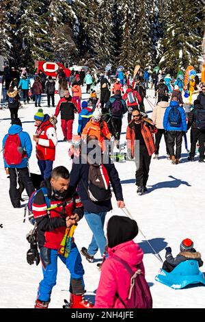 People, visitors, and skiers enjoying the sunny Winter day outside Aleko Hut at 1840m in Vitosha Mountain above Sofia, Bulgaria, Europe, Balkans, EU Stock Photo
