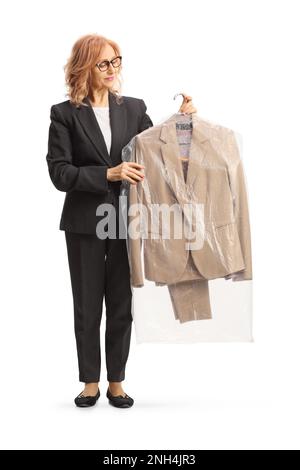 Woman holding suit on a hanger with a plastic dry cleaning bag isolated on a white background Stock Photo