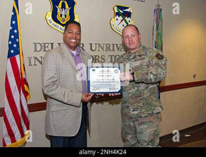 Maj. Robert Glover, 433rd Training Squadron commander,  presents the induction certificate to the squadron’s new honorary commander, Christopher Fairbank, Dean of Students at Founders Classical Academy of Schertz, during the Dec. 12 honorary commander induction ceremony held at Joint Base San Antonio-Randolph, Texas. Stock Photo