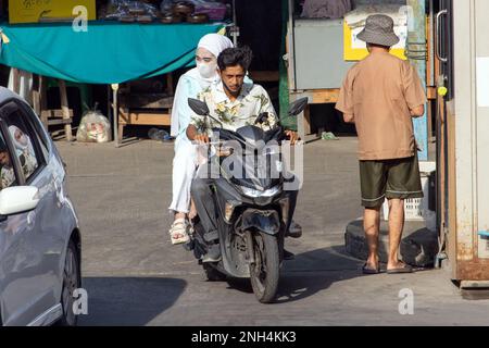 SAMUT PRAKAN, THAILAND, FEB 13 2023, The pair rides on motorcycle at the street. Stock Photo