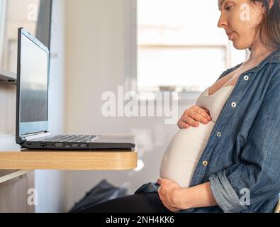 pregnant woman during online medical consultation Stock Photo