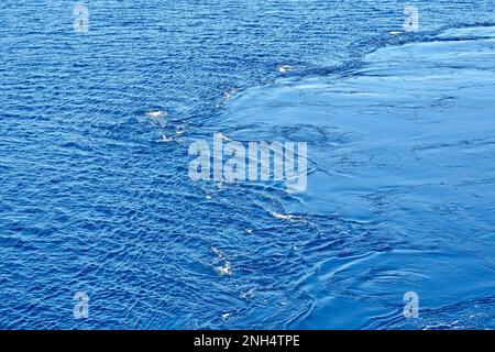 Pattern formed by swirling water in the sea from the propellers of a cruise ship. No people. Copy space. Backgrounds. Stock Photo