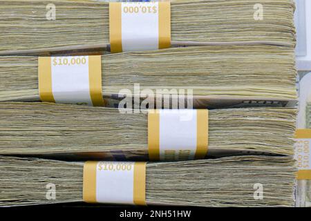Close up side view of 4 straps of ten thousand one hundred US dollar bills stacked on top of each other Stock Photo