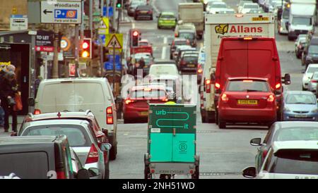 heavy traffic with a bicycle courier on great western road rush hour in Glasgow, Scotland, UK Stock Photo