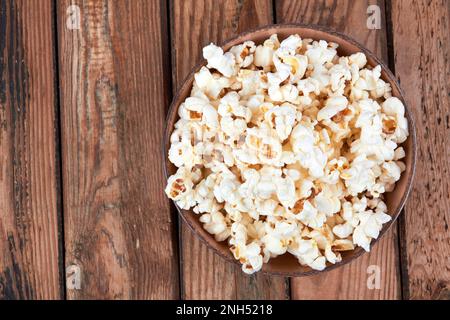 Popcorn in bowl food on wooden background Stock Photo