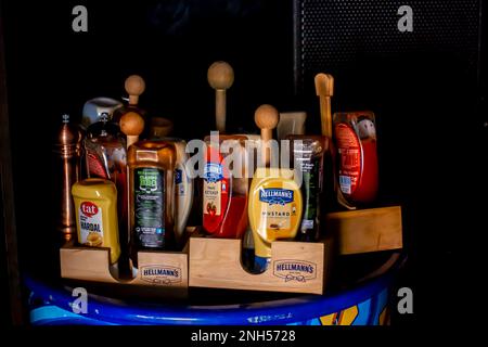Ketchup, mustard, sauce on a tray. Condiments on a tray. Hellmann's branded tray for condiemnts, serving in restaurants Stock Photo