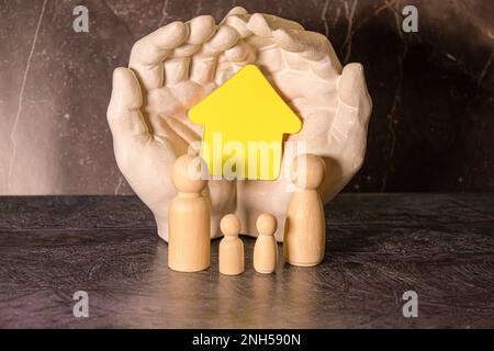 Small wooden figures of family members. Family relationship symbol. Stock Photo