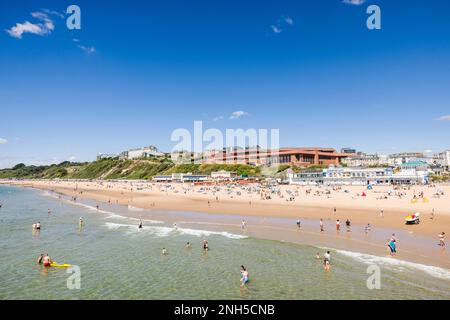 BOURNEMOUTH, UK - July 08, 2022. People enjoying summer by the sea on a sandy beach. Bournemouth, Dorset, UK Stock Photo