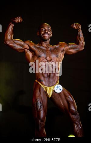 nyzavian dozier a bodybuilding competitor performs a front double bicep pose during the 2022 far east bodybuilding competition at the camp foster base theater okinawa japan july 17 2022 for 23 years marine corps community services has hosted the competition to display the hard work dedication and perseverance of the best bodybuilders in the pacific in a variety of categories falling under figure physique and bodybuilding competitors are judged on muscle symmetry size definition and overall flow of their posing routines 2nh5e7b