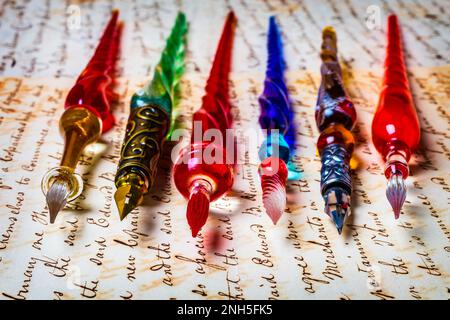 Fine Glass Pens laying on letter, document, writing, message, handwriting, Stock Photo