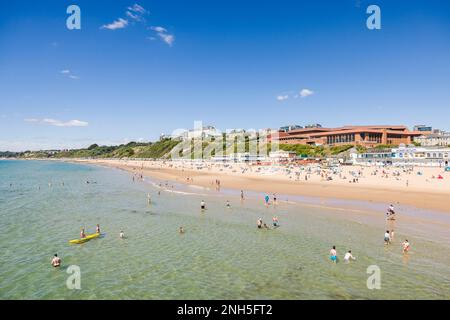 BOURNEMOUTH, UK - July 08, 2022. People enjoying summer by the sea on a sandy beach. Bournemouth, Dorset, UK Stock Photo