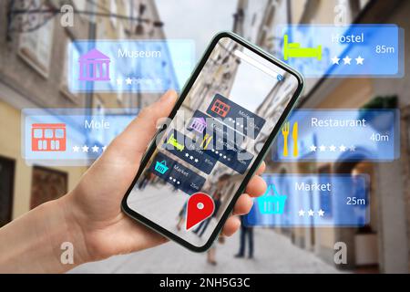 Tourist using online guide application on smartphone for navigation in city, closeup. Augmented reality information technology Stock Photo