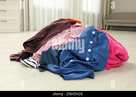 Pile of dirty clothes on floor indoors Stock Photo