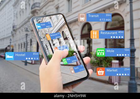 Tourist using online guide application on smartphone for navigation in city, closeup. Augmented reality information technology Stock Photo