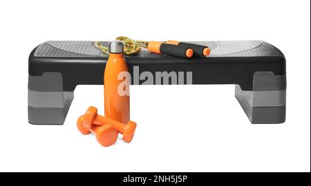 Step platform, jump rope, dumbbells and bottle on white background. Sports equipment Stock Photo