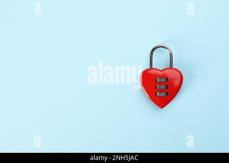 Red heart shaped combination lock on light blue background, top view. Space for text Stock Photo