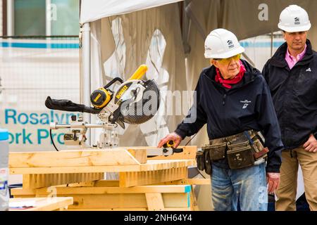93 year old President Jimmy Carter puts his saw skills to use at the Jimmy and Rosalynn Carter Work Project for Habitat for Humanity Edmonton. Stock Photo