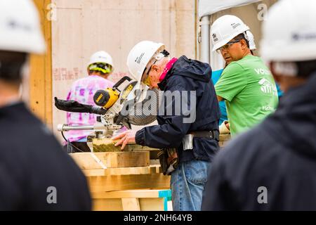 93 year old President Jimmy Carter puts his saw skills to use at the Jimmy and Rosalynn Carter Work Project for Habitat for Humanity Edmonton. Stock Photo