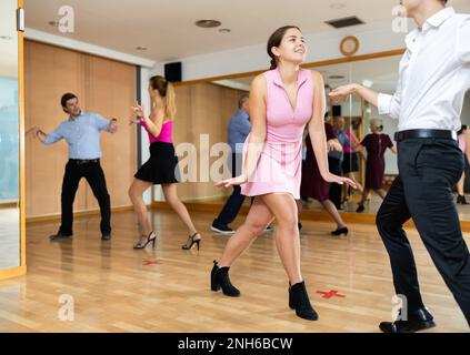 Young pair practicing Latino dance in dance studio Stock Photo