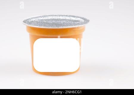 orange peach apricot compote in closed plastic jar on white background with blank label Stock Photo