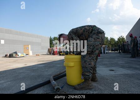 U.S. Marine Corps Lance Cpl. Christopher Ray, a bulk fuels specialist with Marine Wing Support Squadron 171 prepares a hose to receive fuel at Pohang Airport, South Korea, July 19, 2022. The FARP was conducted with the Republic of Korea Marine Corps to promote multinational training and preparedness as a part of the Korean Marine Exercise Program. Stock Photo