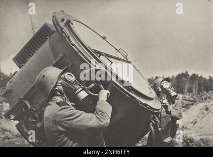 1914-1918. World War I. Two soldiers working with a large Searchlight. They both wear gas masks. Stock Photo