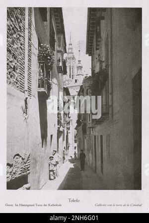 Architecture of Old Spain. Vintage photo of Toledo. Street. In the background tower of the Cathedral Stock Photo