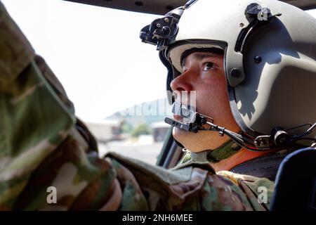 A UH-60 Black Hawk pilot with the 28th Expeditionary Combat Aviation Brigade, 28th Infantry Division, Pennsylvania Army National Guard performs preflight checks during a training mission at Ft. Indiantown Gap, PA. July 20, 2022. Flights are a common occurrence at the Gap and help crews and pilots maintain critical skills needed for missions both domestic and abroad. Stock Photo