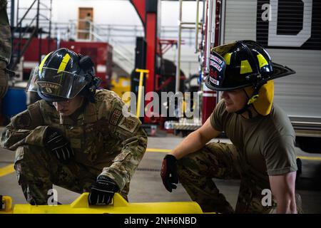 U.S. Air Force Airman 1st Class James Peterson, (left), 8th Civil Engineer Squadron fire protection, Kunsan Air Base, Republic of Korea, and Senior Airman Joseph Jenkins, 100th Civil Engineer Squadron fire protection, inspect their equipment at Royal Air Force Mildenhall, England, July 20, 2022. Firefighters from Kunsan AB collaborated with RAF Mildenhall in preparation of an upcoming training exercise. Stock Photo