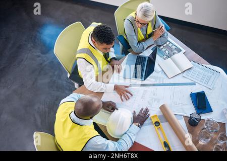 Architect, laptop and team in meeting above for construction or building planning strategy at office. Group of diverse engineers discussing floor plan Stock Photo