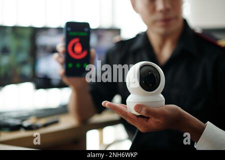 Security guards installing new surveillance equipment in office Stock Photo